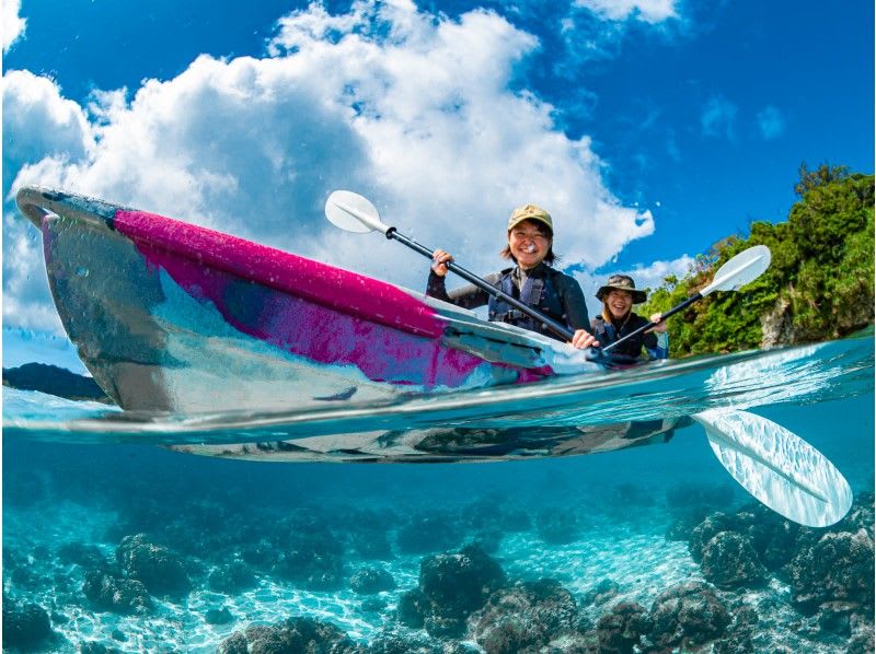 A group speeds across the vibrant turquoise sea on a banana boat, a thrilling marine sports activity at Minna Island.
