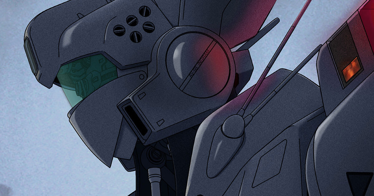 The white Ingram AV-98 robot from the live-action Patlabor stands in a city, illustrating the realism of THE NEXT GENERATION